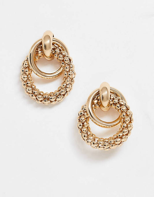 Earrings in linked sleek and textured circles in gold tone